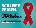 Eine Aids-Schleife und die Aufforderung "Schleife zeigen" weist auf den Welt-Aids-Tag am 1. Dezember hin